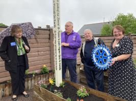 RI Pres. DG Malcolm unveiling the Peace Pole with David Thomas and Pres. Donna Wallbank 
